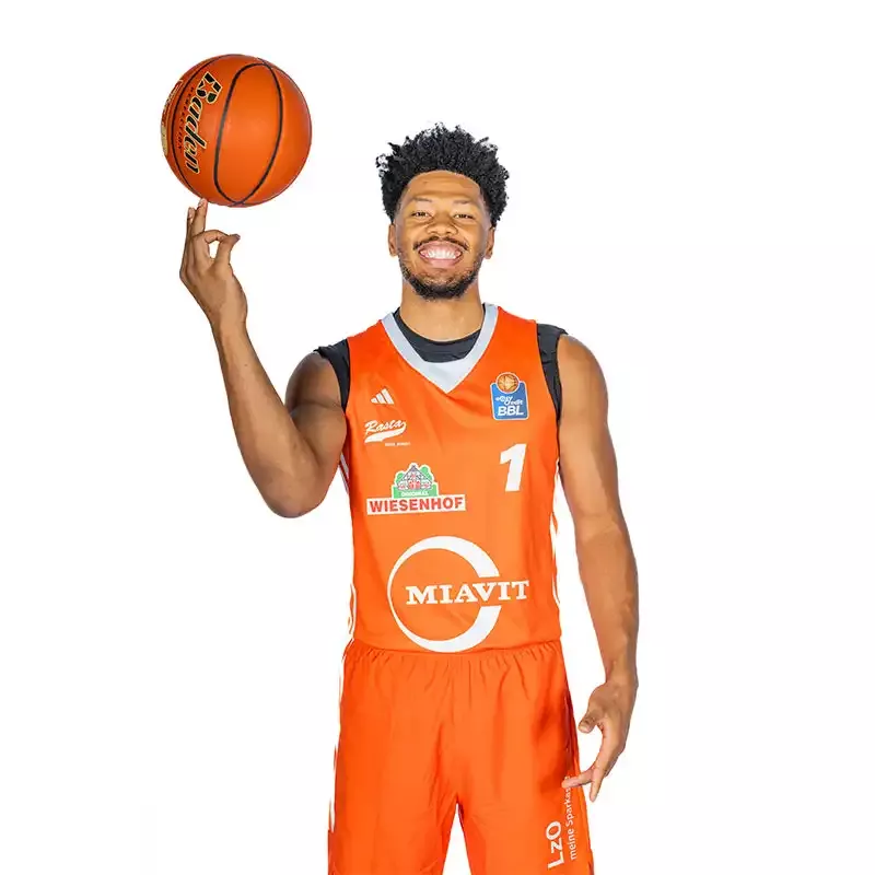 Mann von vorne mit Basketball auf dem Finger im Adidas Trikot "Home" Saison 2024/25 - unveredelt in orange.